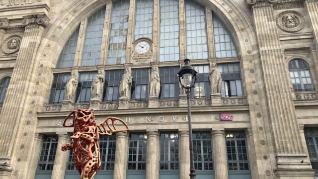 パリ北駅の駅舎。GARE DU NORDの文字と時計、彫像が並ぶファサード